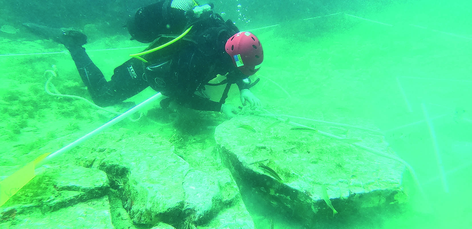 Realizando mediciones de un yacimiento arqueológico submarino.