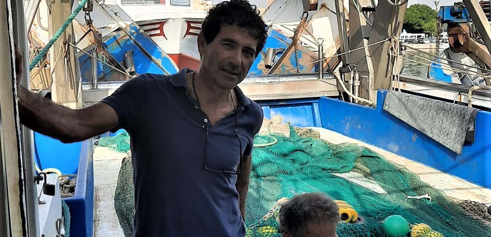 Juan Ruiz Parra junto a un pescador en el puerto de Águilas (Murcia)
